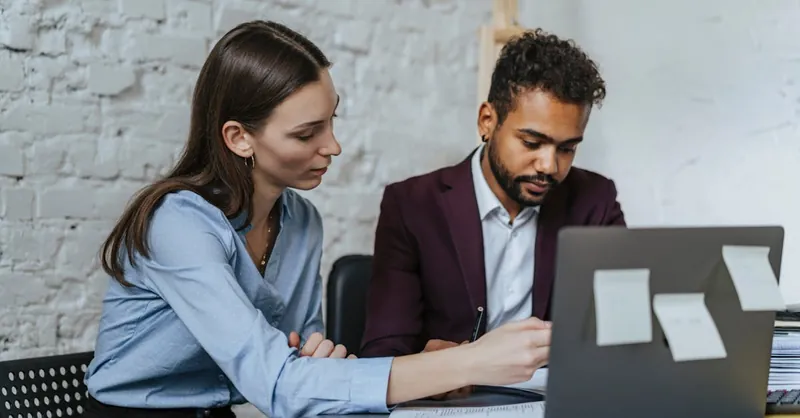 Focused business professionals collaborating in a modern office environment.