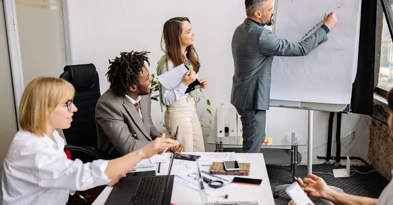 Business professionals brainstorming and collaborating during a team meeting in a modern conference room.