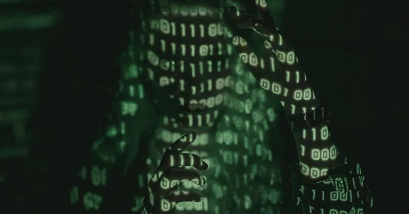 An unrecognizable person with binary code projected, symbolizing cybersecurity and digital coding.