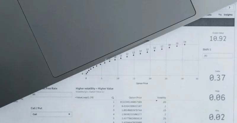 A top-down view of analytical data sheets and a laptop, ideal for business analysis themes.