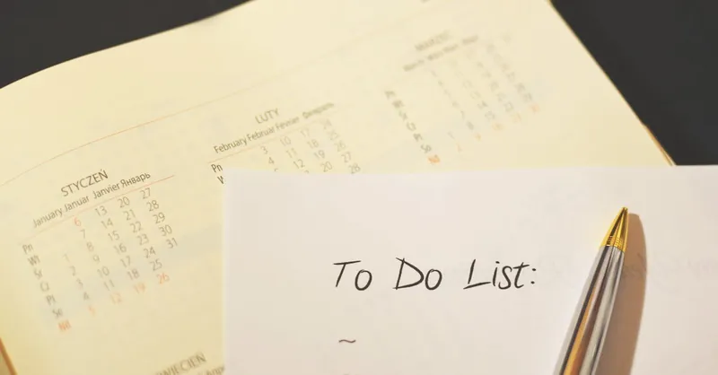 Close-up of a calendar and to-do list on a desk, emphasizing planning and organization.